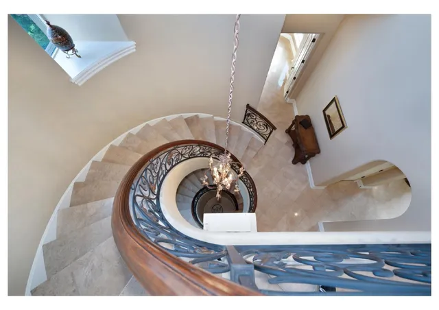 a living room with furniture a flat screen tv and a floor to ceiling window