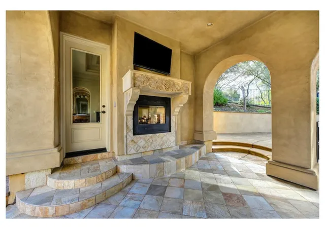 a view of a backyard with table and chairs potted plants and entertaining space