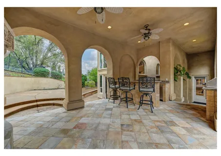a view of a house with backyard porch and sitting area