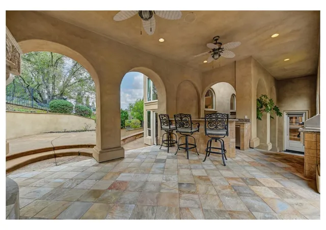 a view of a house with backyard porch and sitting area