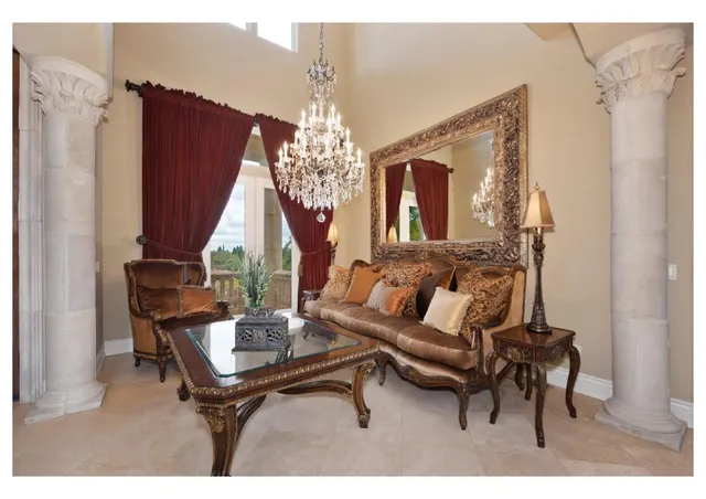 a dining room with furniture and a large window