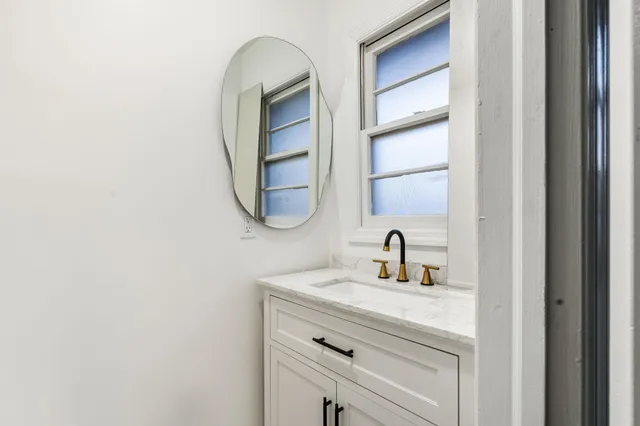 a bathroom with a sink and a mirror