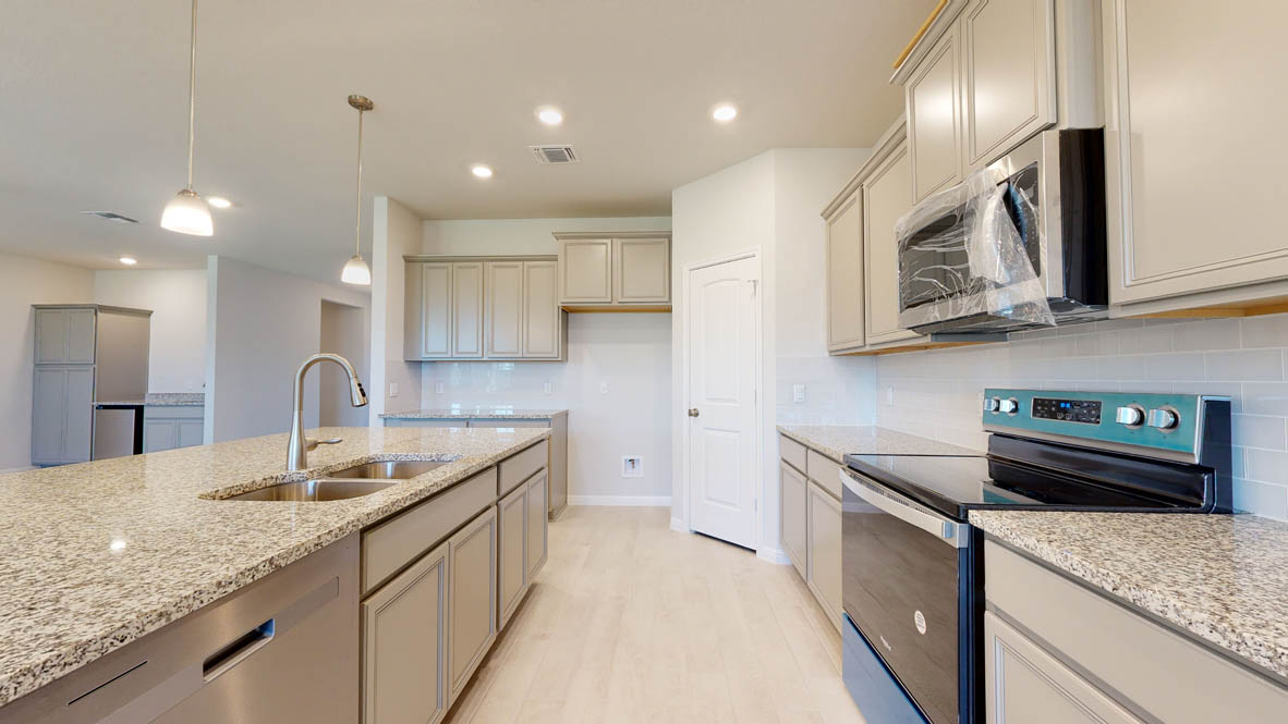 808 Gauge Road Thorndale, TX 76577 - Photo 4 of 31 Granite counters and stainless steel appliances furnish this spacious, light-filled culinary haven.