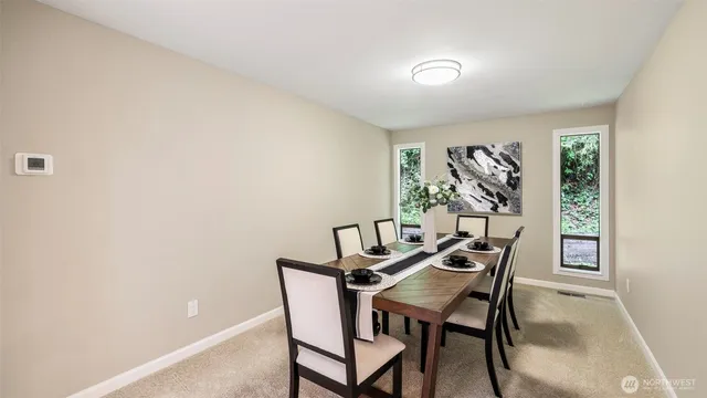 a view of a dining room with furniture and a window