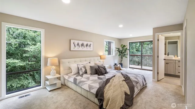 a bedroom with a large bed and a large window