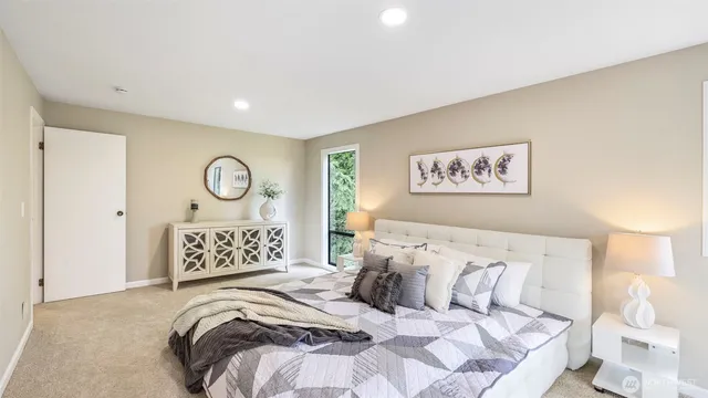 a bedroom with a bed and painting on the wall