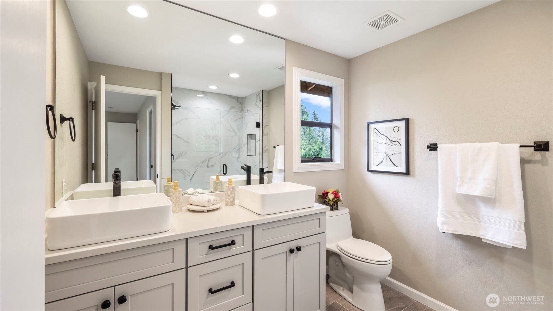 17606 Northeast 27th Street Redmond, WA 98052 - Photo 14 of 32 a bathroom with a double vanity sink toilet and mirror