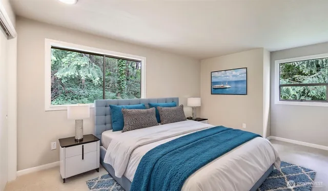 a bedroom with a large bed and a window