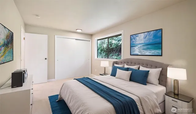 a bedroom with a bed and a flat screen tv