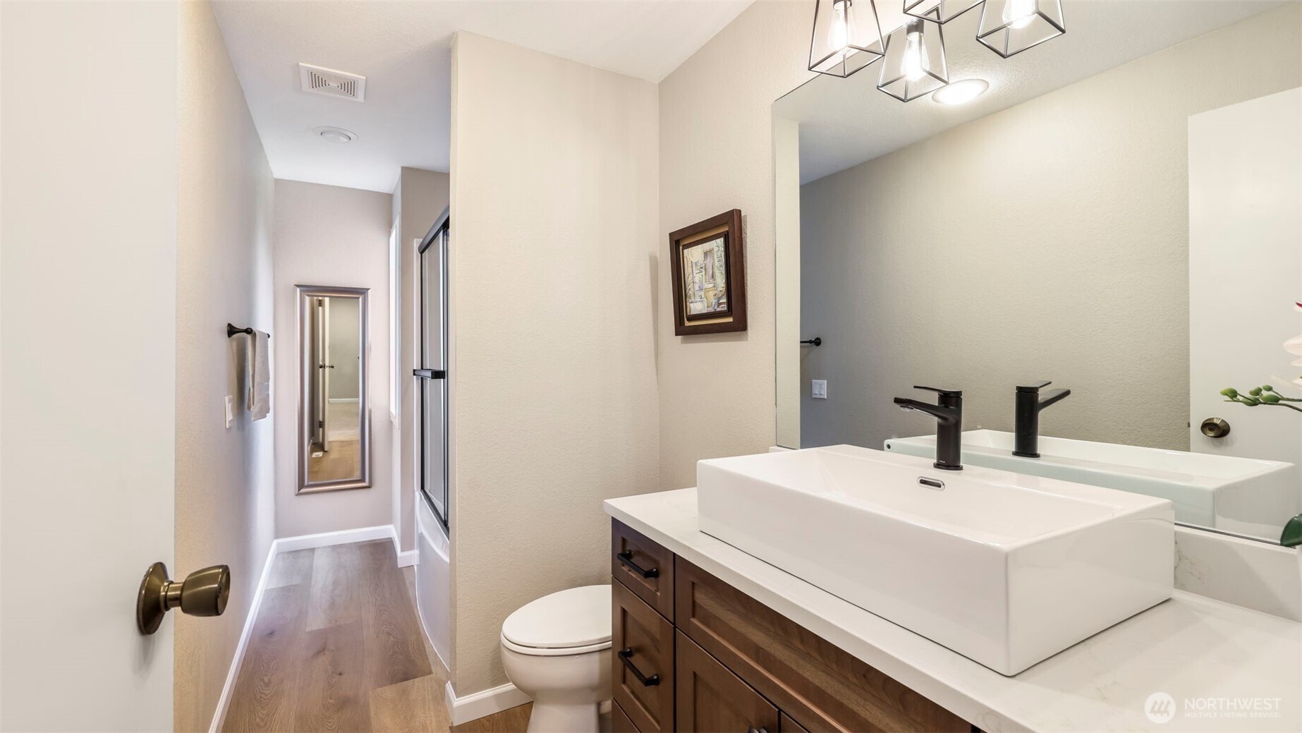 17606 Northeast 27th Street Redmond, WA 98052 - Photo 17 of 32 a bathroom with a sink a toilet and shower