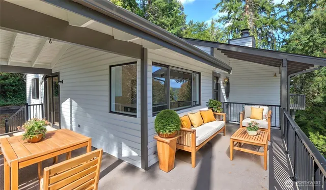 a backyard of a house with barbeque oven table and chairs