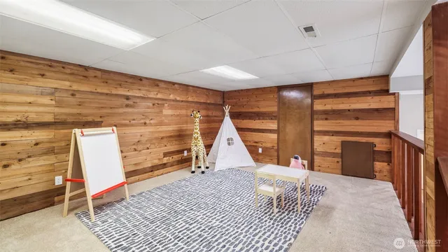 a view of an empty room with wooden floor and windows