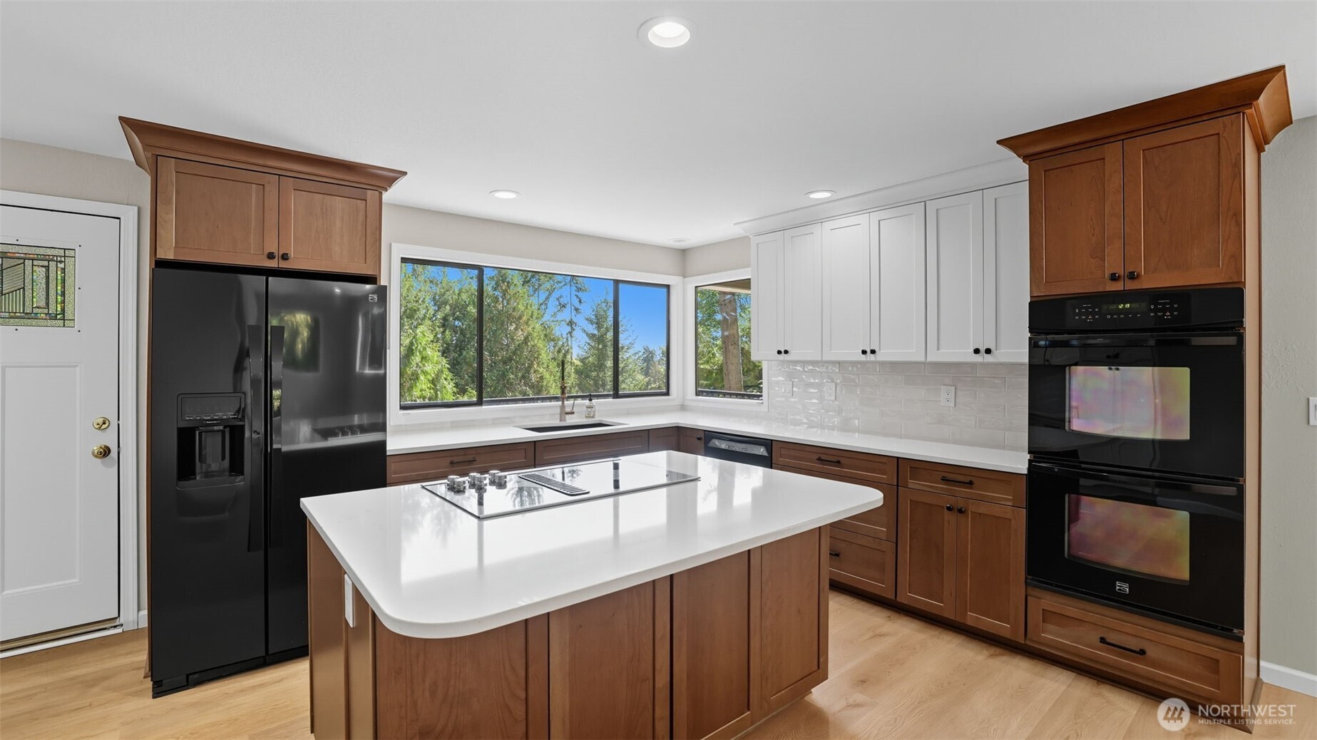 17606 Northeast 27th Street Redmond, WA 98052 - Photo 8 of 32 a kitchen that has a sink stainless steel appliances a counter space and a window