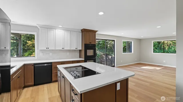 a kitchen with a stove a sink dishwasher and a refrigerator