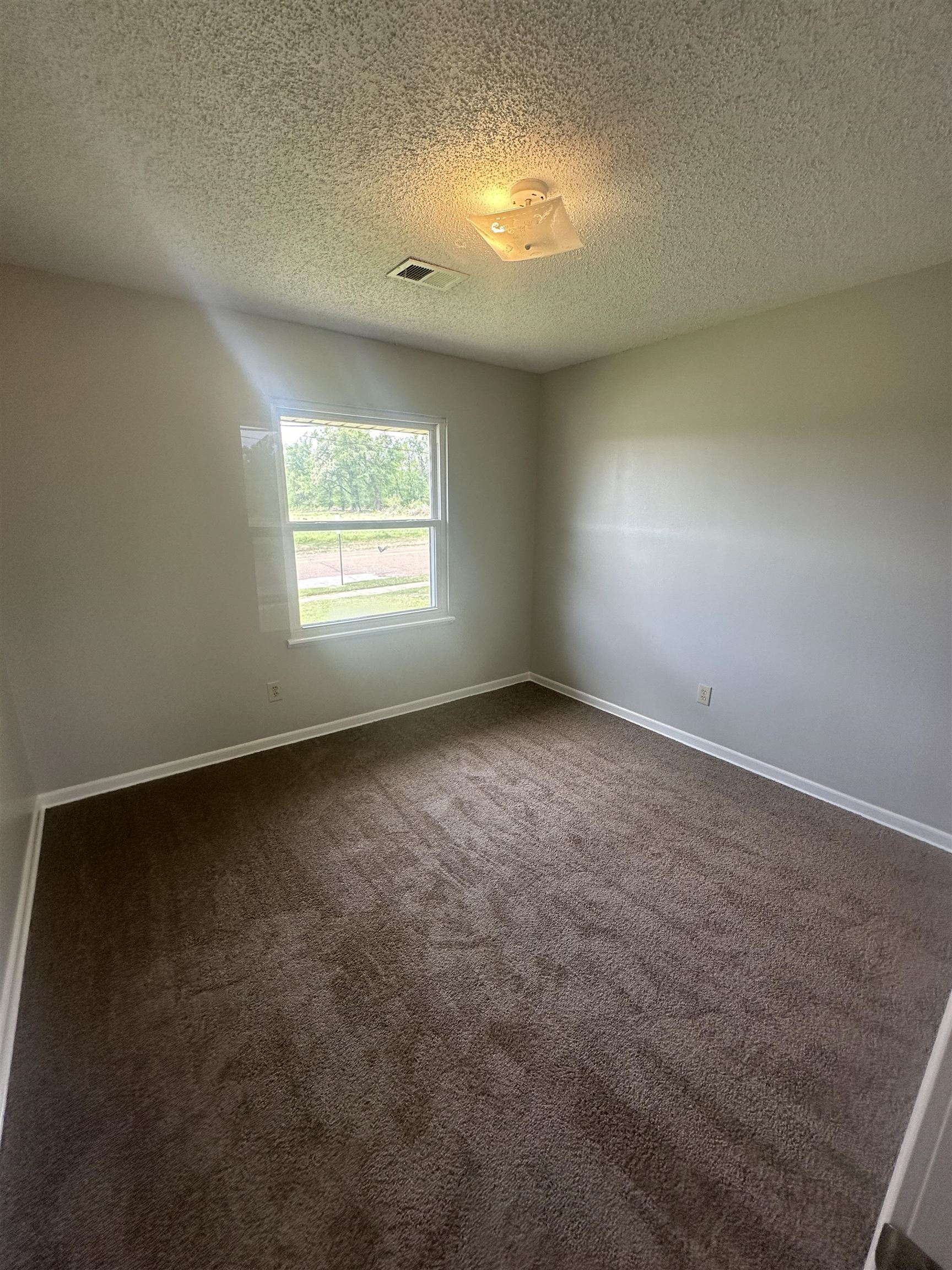7882 Quito Road Millington, TN 38053 - Photo 6 of 9 an empty room with a window