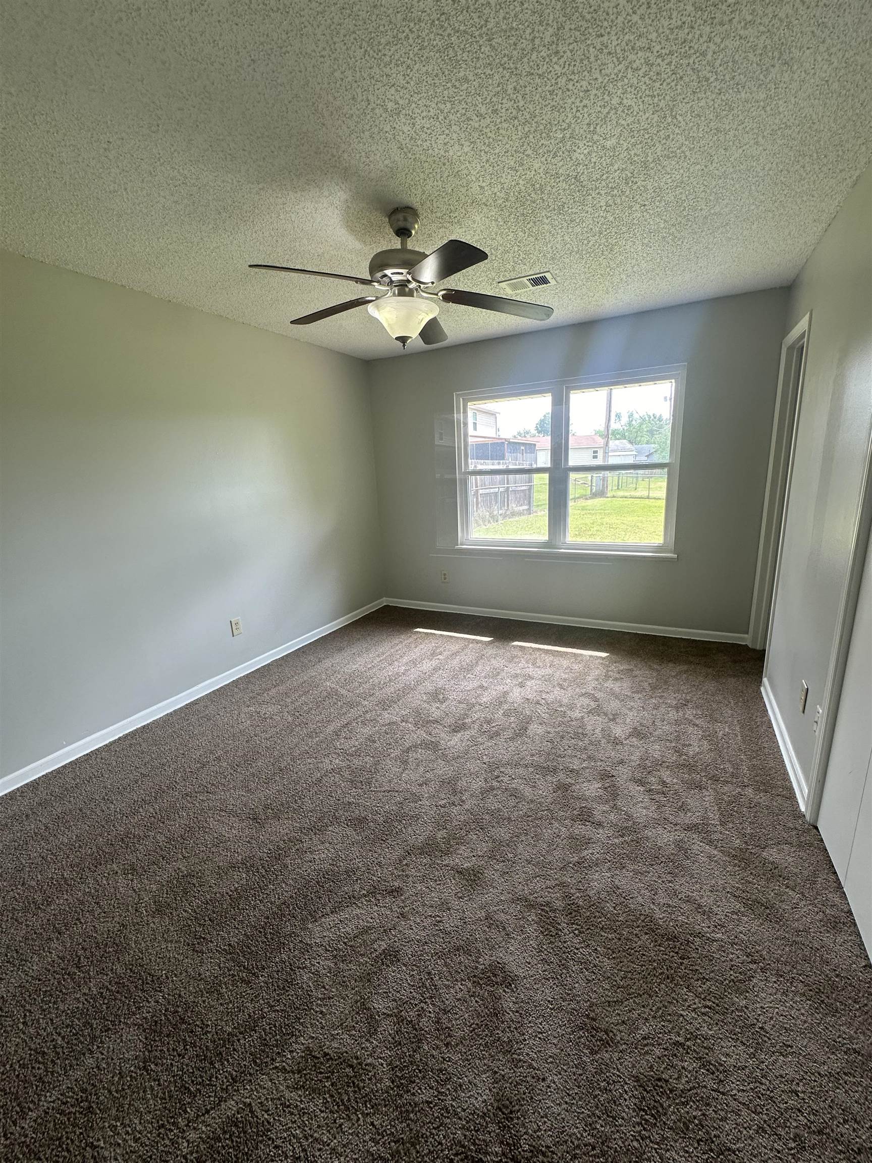 7882 Quito Road Millington, TN 38053 - Photo 9 of 9 an empty room with a window and a ceiling fan