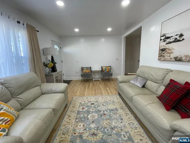 a living room with furniture and a rug