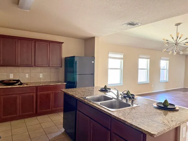 a kitchen with a sink and cabinets