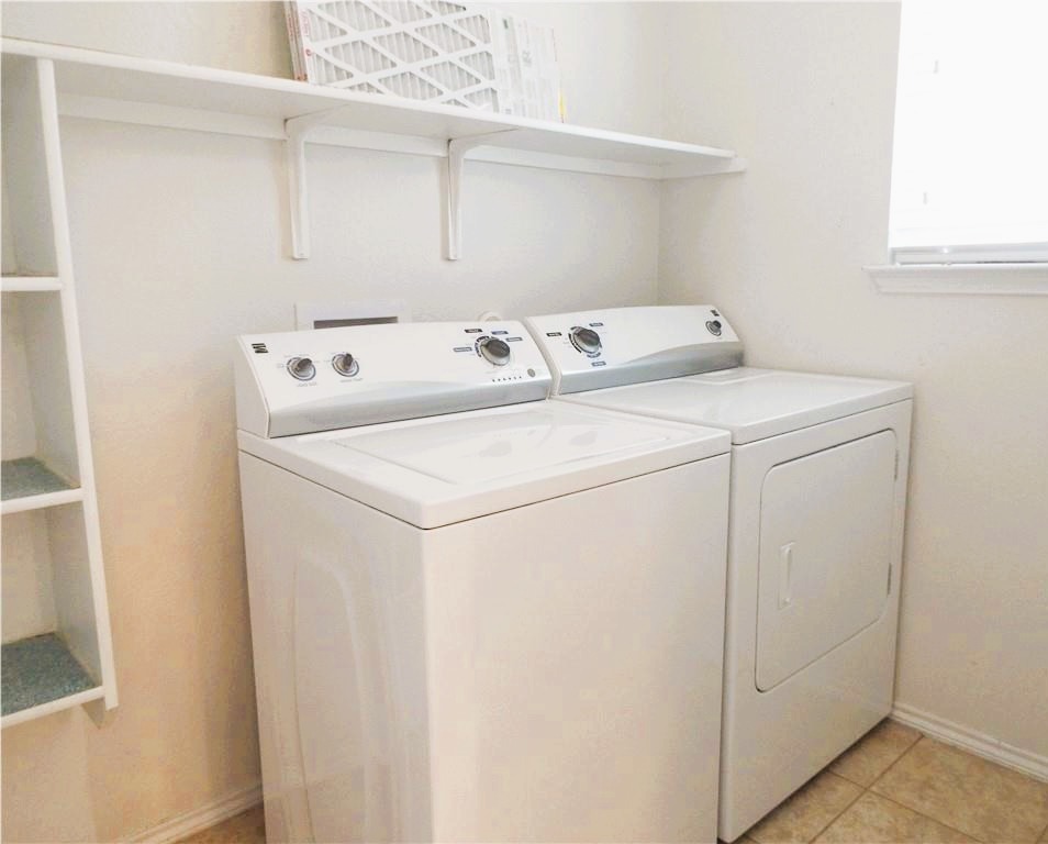 3609 Eagle Fledge Terrace Pflugerville, TX 78660 - Photo 12 of 15 Laundry room with washing machine and clothes dryer and light tile patterned flooring
