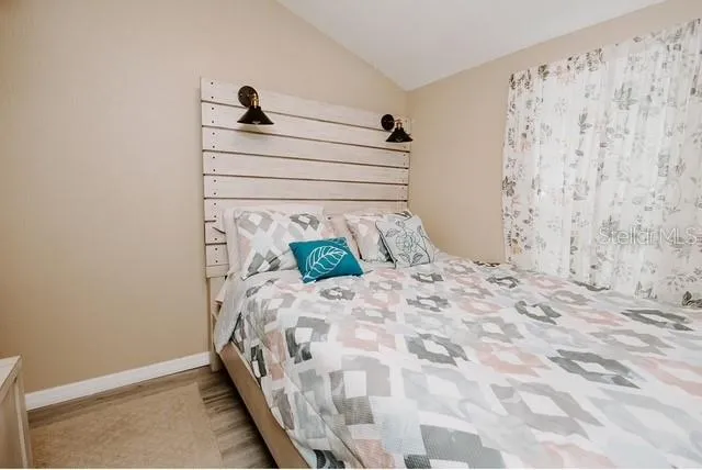 a bedroom with a bed and a window