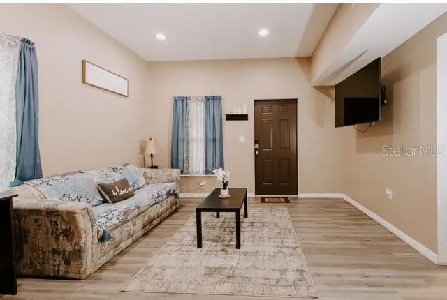 a living room with furniture and a flat screen tv