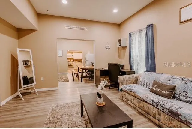 a living room with furniture rug and wooden floor