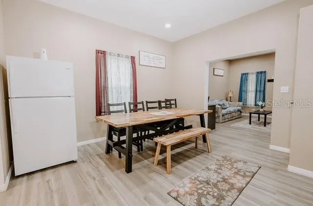 a view of a dining room with furniture and wooden floor