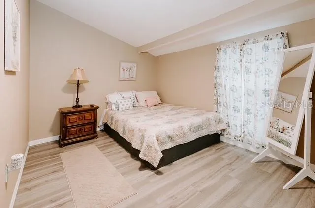 a bedroom with a bed and a mirror