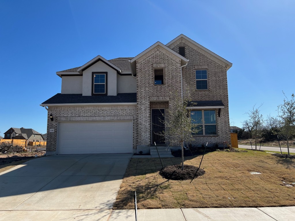 a front view of a house with a yard