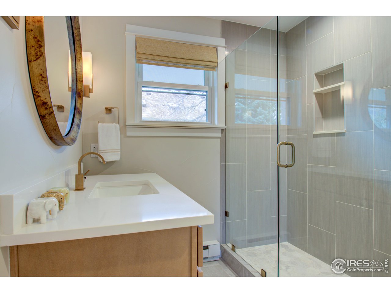3035 Galena Way Boulder, CO 80305 - Photo 17 of 40 a bathroom with a sink vanity and a mirror