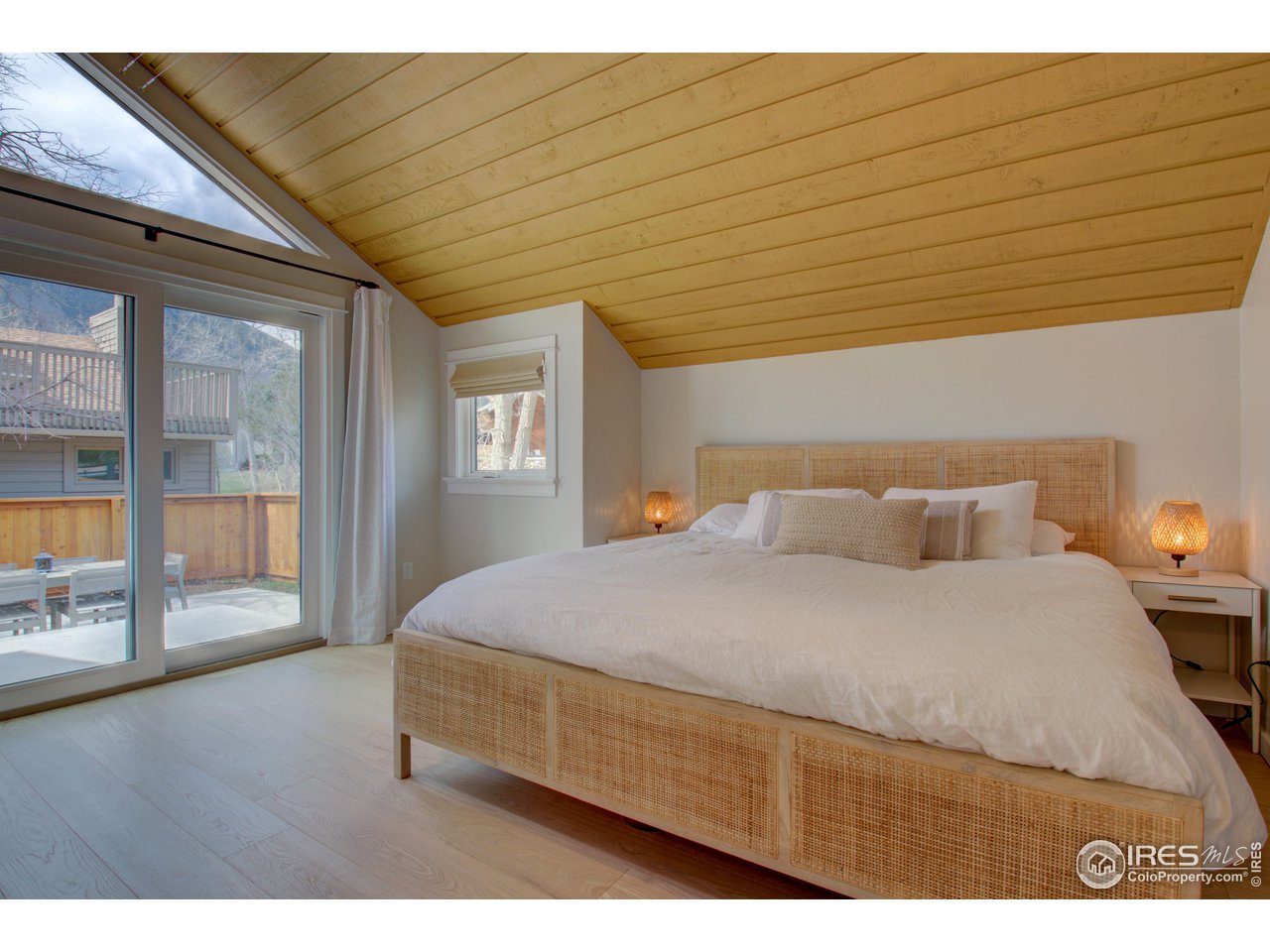 3035 Galena Way Boulder, CO 80305 - Photo 18 of 40 a bedroom with a large bed and wooden floor