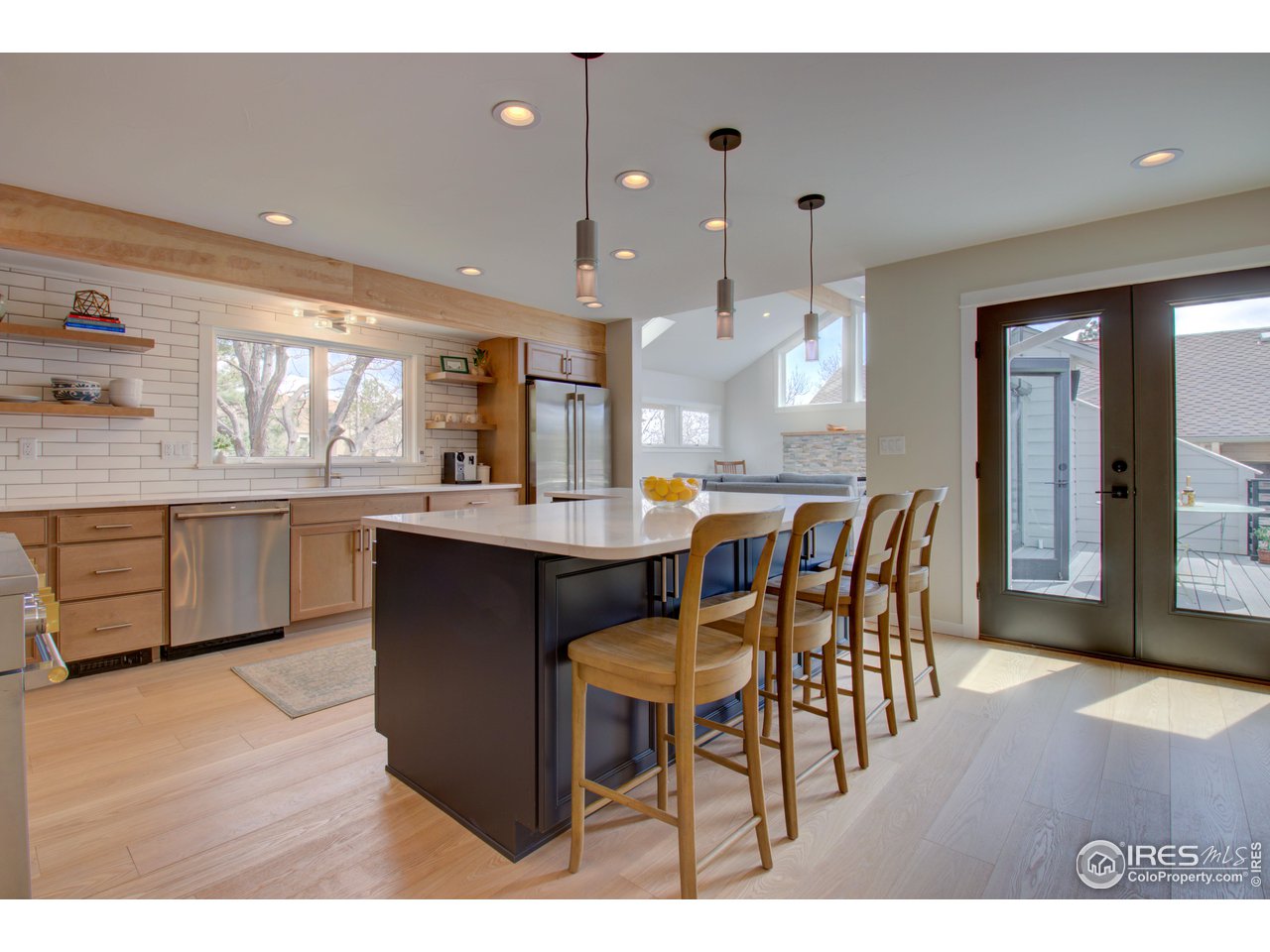 3035 Galena Way Boulder, CO 80305 - Photo 5 of 40 a kitchen with a dining table chairs and white cabinets