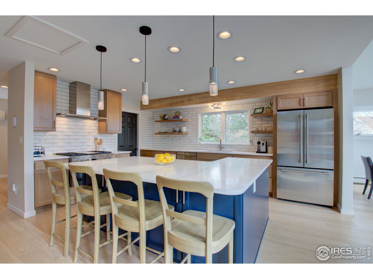 3035 Galena Way Boulder, CO 80305 - Photo 8 of 40 a kitchen with stainless steel appliances granite countertop a kitchen island a stove and a refrigerator