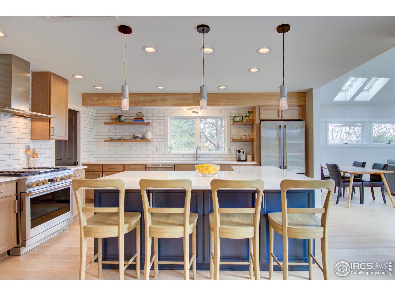 3035 Galena Way Boulder, CO 80305 - Photo 10 of 40 a kitchen with a dining table chairs sink and cabinets