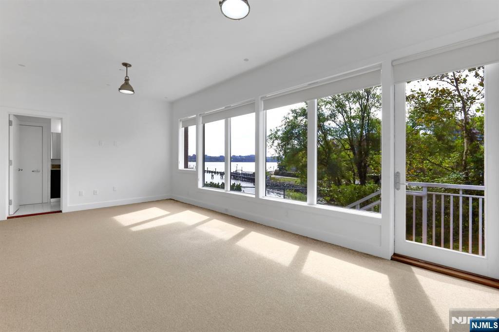 22 Vela Way Edgewater, NJ 07020 - Photo 29 of 44 a view of an empty room with windows and balcony