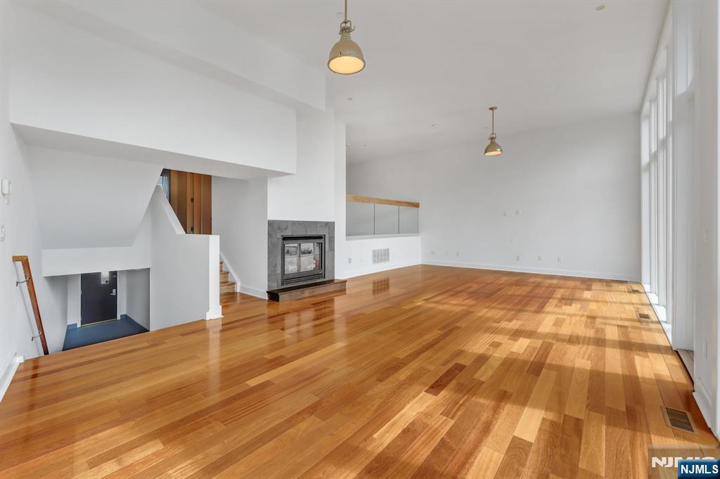 22 Vela Way Edgewater, NJ 07020 - Photo 5 of 44 a bedroom with a bed and a fireplace