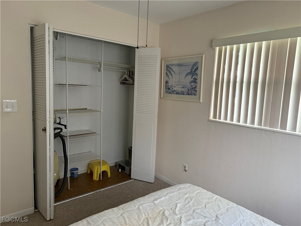 2211 Orchid Road Lehigh Acres, FL 33936 - Photo 11 of 11 a bedroom with a bed and a window