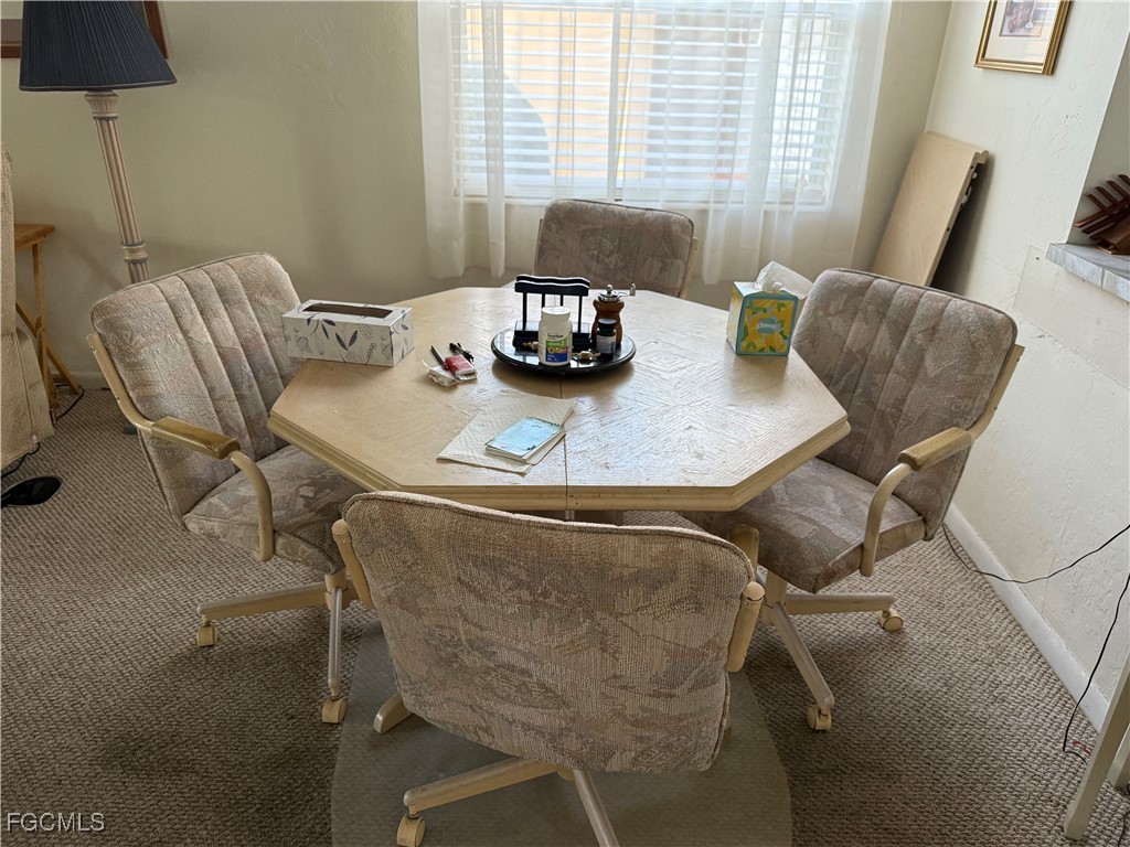 2211 Orchid Road Lehigh Acres, FL 33936 - Photo 6 of 11 a dining room with furniture and wooden floor