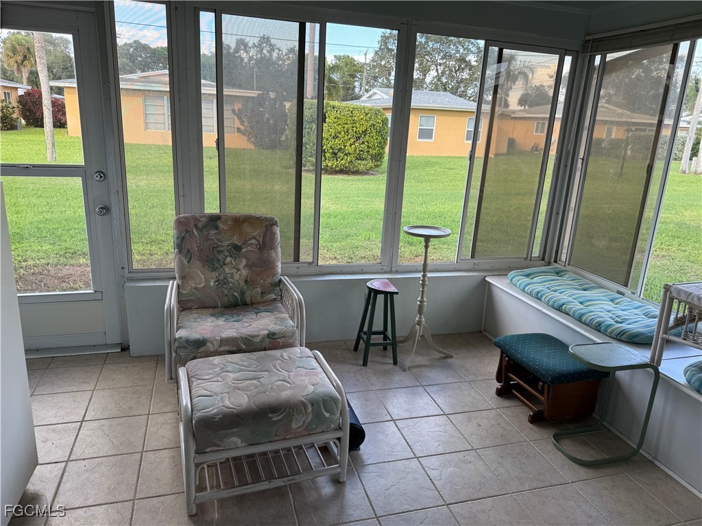 2211 Orchid Road Lehigh Acres, FL 33936 - Photo 7 of 11 a living room with a couch and a table
