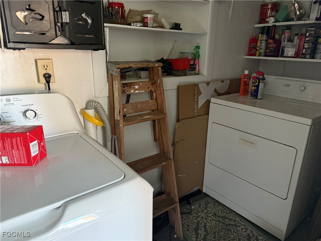 2211 Orchid Road Lehigh Acres, FL 33936 - Photo 8 of 11 a storage room with washer and dryer