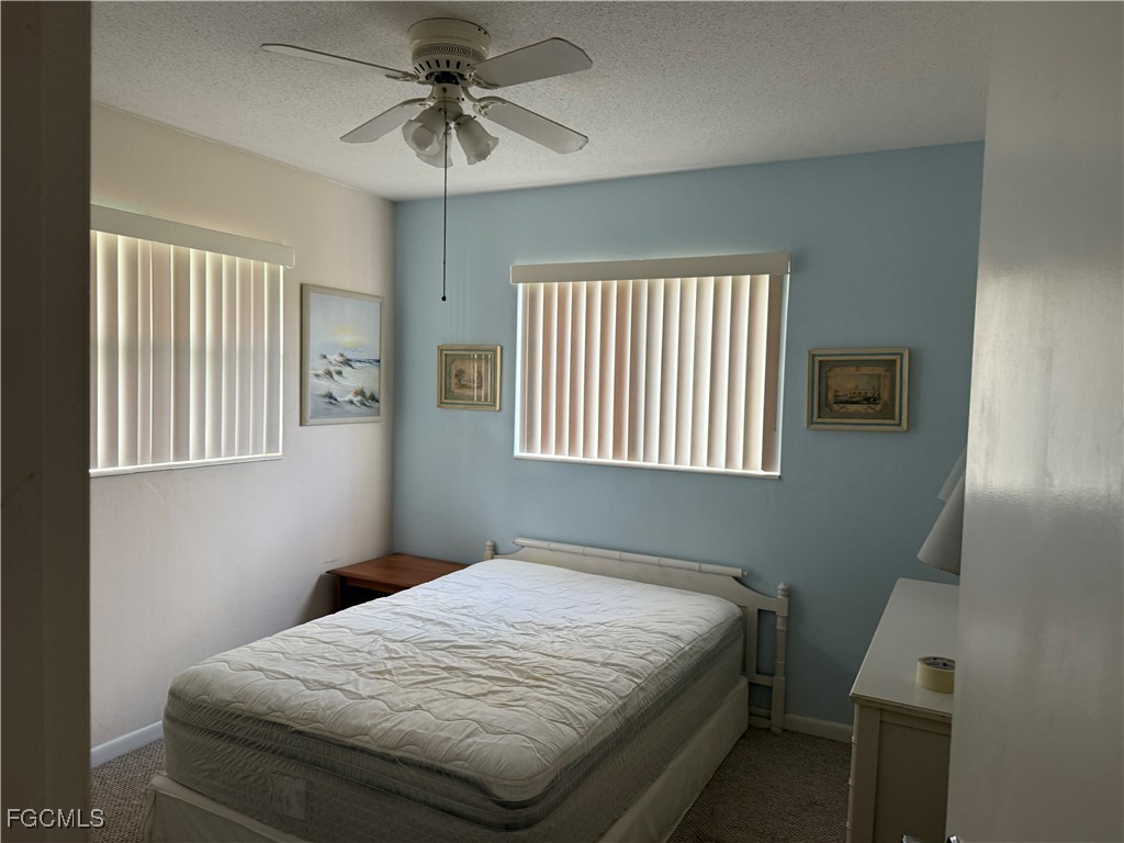 2211 Orchid Road Lehigh Acres, FL 33936 - Photo 10 of 11 a bedroom with a bed and a window