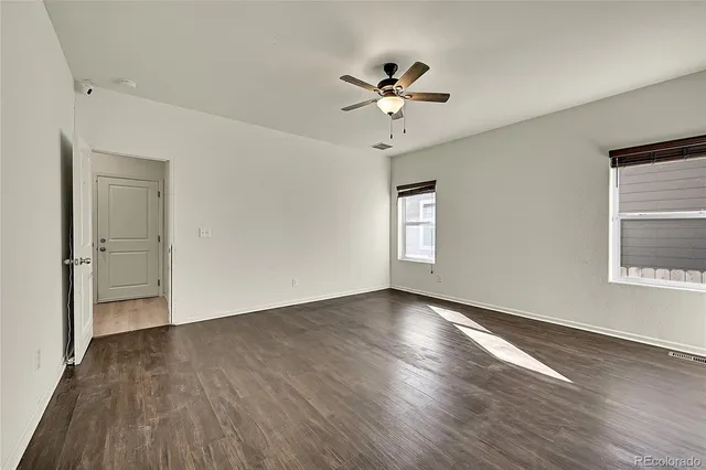 a bathroom with a granite countertop sink and a toilet