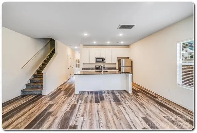 a view of kitchen with sink microwave and stove