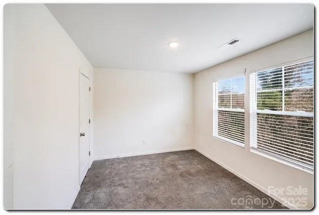 a view of a livingroom with an empty space and a window