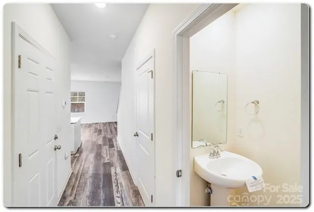 a bathroom with a sink and mirror with toilet
