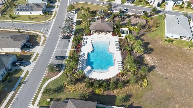 an aerial view of a residential houses with outdoor space