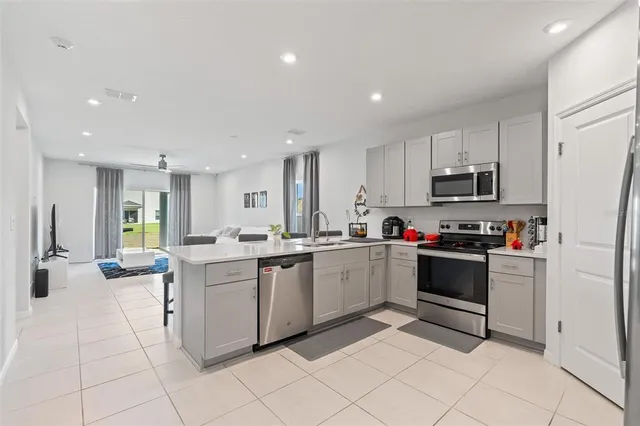 a kitchen with cabinets and chairs