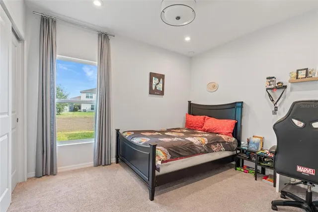 a bed room with a bed and a chair