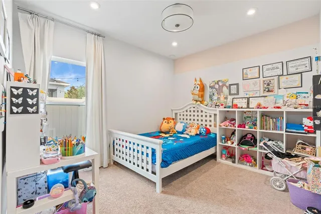 a bedroom with baby crib and a window