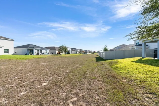 a view of a lake with houses in the background
